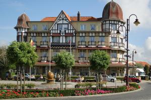 a large building with a turret on a street at Apartment Valdemosa in De Haan