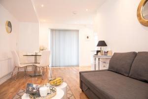 a living room with a couch and a table at Sunshine Place in Enfield