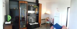 a living room with a tv and a cabinet at La casa sui trulli in Alberobello