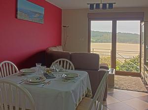 a dining room with a table and a couch at Casa Mar de Fondo in A Telleira +28 photos