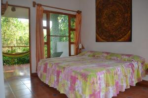 a bedroom with a bed and a sliding glass door at Aventurec in Piedra Pinta