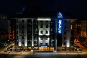 a building with a sign on it at night at Adresin Hotel in Edirne
