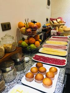 a buffet with several plates of food and fruit at Hotel Terrasur in Talcahuano