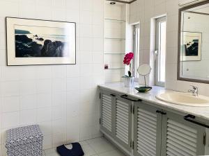 a bathroom with a sink and a mirror at Duplex playa chica in Puerto del Rosario +35 photos