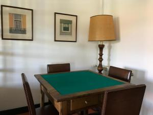 a ping pong table with chairs and a lamp at Quinta do Ladário in Várzea Ovelha e Aliviada