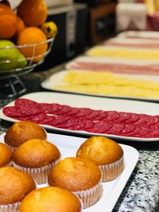 a bunch of cupcakes on plates on a table at Hotel Terrasur in Talcahuano