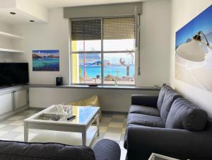 a living room with a couch and a table at Duplex playa chica in Puerto del Rosario