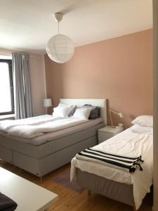 a bedroom with two beds and a pendant light at Kemi city center 2 room and kitchen FREE PRIVATE PARKING in Kemi