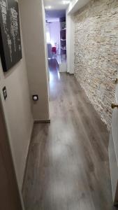 a hallway of an office with a stone wall at Moderno apartamento en el parque de cabecera in Valencia