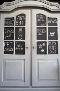 a white door with chalkboard signs on it at De Johanneshoeve in Westerhaar-Vriezenveensewijk