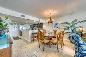 a kitchen and dining room with a table and chairs at Shores Club 105 - Shores Club Retreat in Daytona Beach Shores