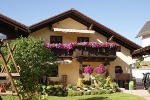 a house with flowers on a balcony at Haus Steinröschen in Seefeld in Tirol