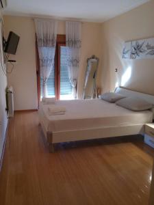 a bedroom with a large bed and a window at Apartman Ćeran in Herceg-Novi
