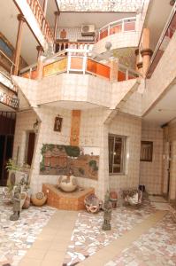 a large room with a fountain in a building at Benin Hotel Terminus in Cotonou