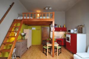 a room with a bunk bed and a kitchen at Hastal Gallery in Prague