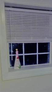 a figurine of a woman in a window at Cheap East Knoxville Basement Studio in Knoxville