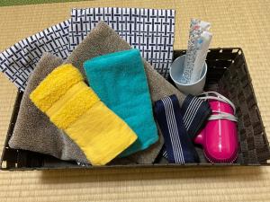 a tray of toothbrushes, toothpaste, toothpaste tubes, and at Asakusa Ryokan Toukaisou in Tokyo