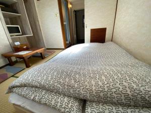 Postel nebo postele na pokoji v ubytování Asakusa Ryokan Toukaisou