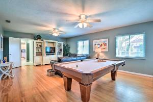 a living room with a pool table in it at Steps to Daytona Beach Updated Home with Deck! in Daytona Beach