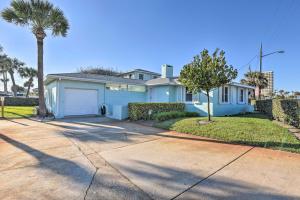 a house with a garage and a palm tree at Steps to Daytona Beach Updated Home with Deck! in Daytona Beach