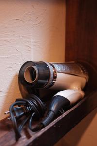 a flashlight sitting on a shelf next to a wall at 一棟貸ゲストハウス 傾㐂屋 Kabukiya in Hiroshima +16 photos