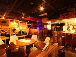 a restaurant with a table and chairs and a bar at Hotel Grace Hakuba in Hakuba