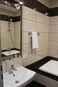 a bathroom with a sink and a mirror at Ліжниця in Radekhov +63 photos