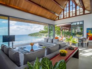 an open living room with a view of the ocean at Malaiwana Villas in Nai Thon Beach