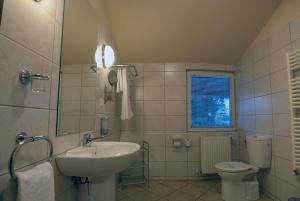 a bathroom with a sink and a toilet at Hotel Baneasa Parc in Bucharest