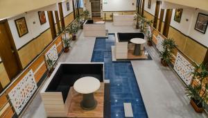 an overhead view of the lobby of a building with blue tiles at The Altruist Navi Mumbai Hotel in Navi Mumbai