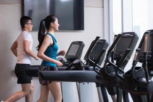 two people walking on treadmill in a gym at Crowne Plaza Macau, an IHG Hotel in Macau
