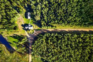 an aerial view of a house in the middle of a forest at Bergervilla Boutique Guest House & SPA in Mežmuiža