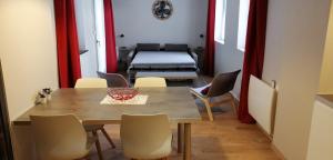 a dining room with a table and chairs and a bed at Gite Côté Cour Colmar in Colmar