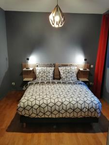 a bedroom with a bed and a chandelier at Gite Côté Cour Colmar in Colmar