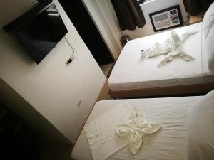 Postel nebo postele na pokoji v ubytování Hotel Rupert A Baler