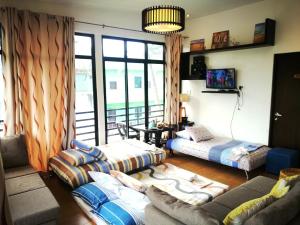 a living room with two couches and a balcony at Casa Herminia Baler in Baler