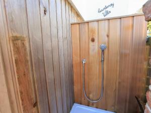 a bathroom with a shower in a wooden wall at Courtenay Villa in Salcombe +37 photos