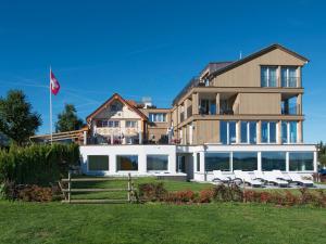 a large building with chairs in front of it at Hotel Landgasthof Eischen in Appenzell