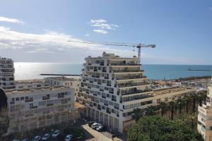 a crane on top of a building next to the ocean at LE MARADIVA - P3 vue imprenable mer-garage - plages in La Grande-Motte