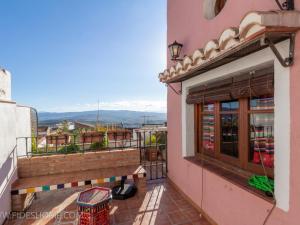 a balcony of a building with a bench on it at Casa maria la conejera in Nigüelas