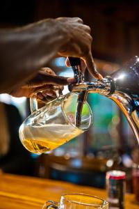 a person is pouring wine into a glass at Palmwag Campsite in Palm