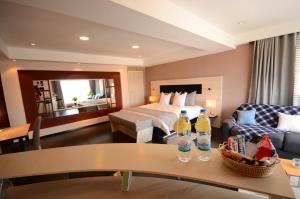 a hotel room with a bed and two bottles on a table at Hotel La Villette in Antananarivo