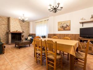 a dining room with a table and chairs and a fireplace at Venta del alamo in Dúrcal