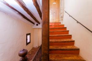 a staircase in a building with wooden beams at Apartamentos Casa Samper in Santa Eulalia de Gállego +4 photos