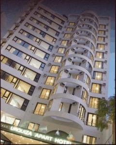a large white building with many windows at night at Urquiza Apart Hotel & Suites in Rosario
