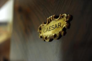 a gold door handle with the name of a case agent at Houspitality Caesar Bed & Breakfast in Rome
