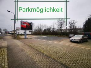 una señal para un estacionamiento con un coche en una calle en Pension Bremer, en Lindenthal