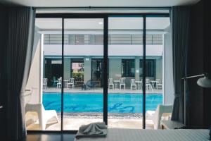 a view of a swimming pool from a hotel room at Bluemoon in Cha Am