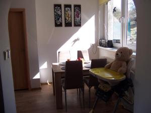 een teddybeer op een stoel naast een tafel bij Salaš-dům pro společnou dovolenou až 14 osob in Salaš