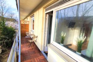 a balcony of a house with a window and plants at Work & Stay im Herzen von Celle in Celle